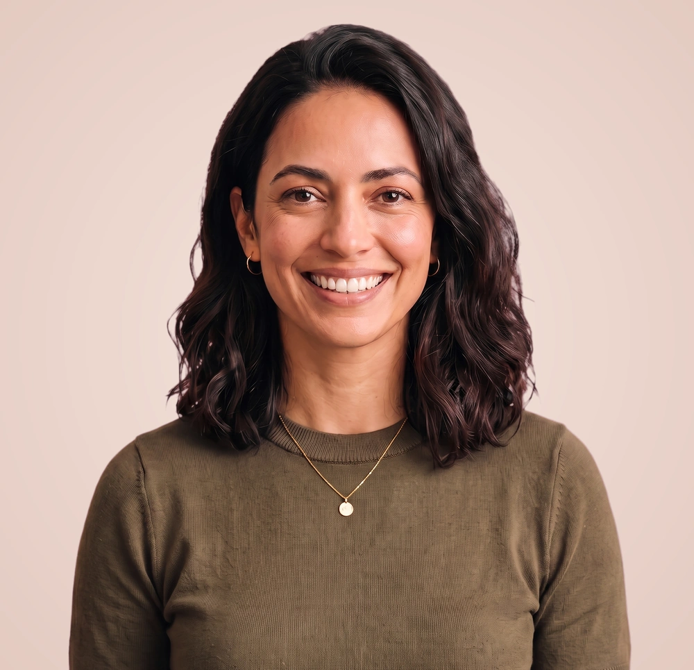 Smiling operations lead in an olive knit tee looking straight at the camera